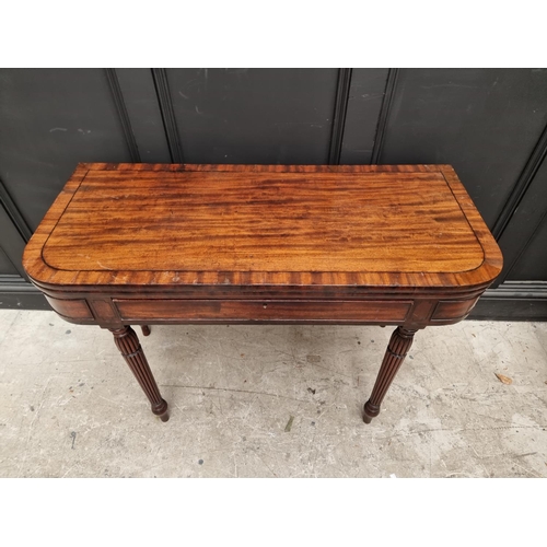 1097 - An early 19th century mahogany and crossbanded tea table, with double gateleg, frieze drawer an... 