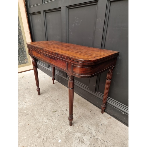 1097 - An early 19th century mahogany and crossbanded tea table, with double gateleg, frieze drawer an... 