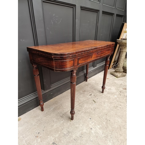 1097 - An early 19th century mahogany and crossbanded tea table, with double gateleg, frieze drawer an... 