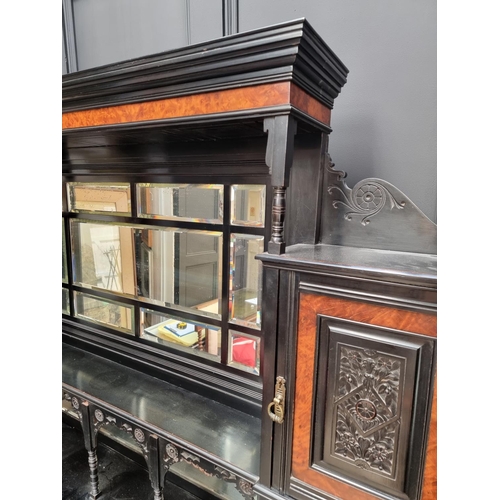 1098 - A large and impressive Aesthetic ebonized and amboyna mirror back side cabinet, 168.5cm wide.... 