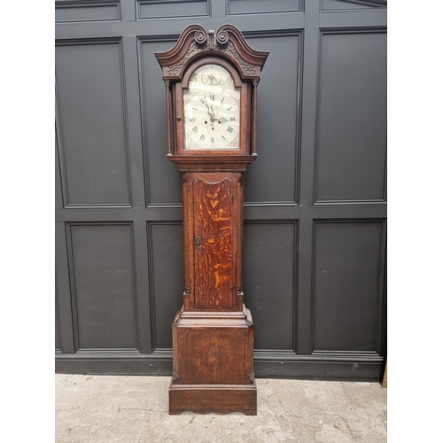 1103 - A George III oak and mahogany crossbanded eight day longcase clock, the 13in painted arched dial ins... 