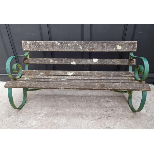 1107 - An old green painted wrought iron garden bench, 150cm wide. 