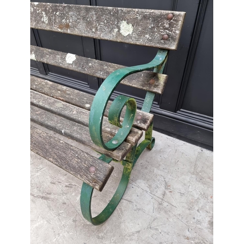 1107 - An old green painted wrought iron garden bench, 150cm wide. 