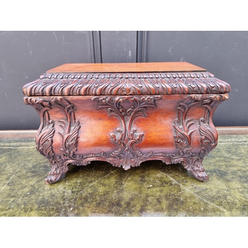 1112 - A reproduction carved hardwood bombe tea caddy and cover, in the rococo style, 30.5cm wide.... 