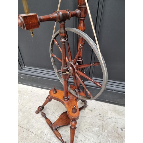 1117 - A good antique fruitwood and brass mounted spinning wheel, 118cm high.