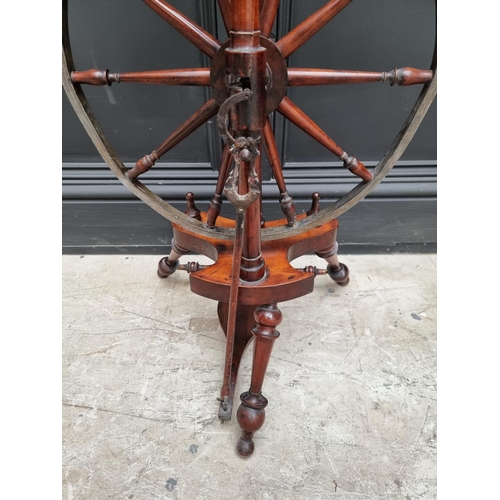 1117 - A good antique fruitwood and brass mounted spinning wheel, 118cm high.