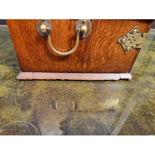 1119 - A circa 1900 oak and electroplate mounted combined tantalus, cigar and games box, the apron drawer w... 