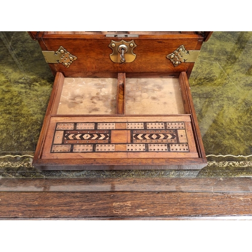 1119 - A circa 1900 oak and electroplate mounted combined tantalus, cigar and games box, the apron drawer w... 