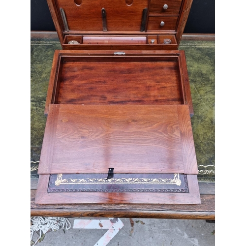 1120 - An elaborate early 20th century figured walnut desk box, 43cm wide. 