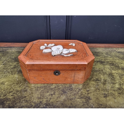 1121 - A Japanese elm and bone casket, of canted rectangular form, 23cm wide. 