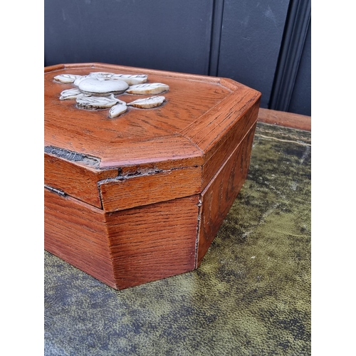 1121 - A Japanese elm and bone casket, of canted rectangular form, 23cm wide. 