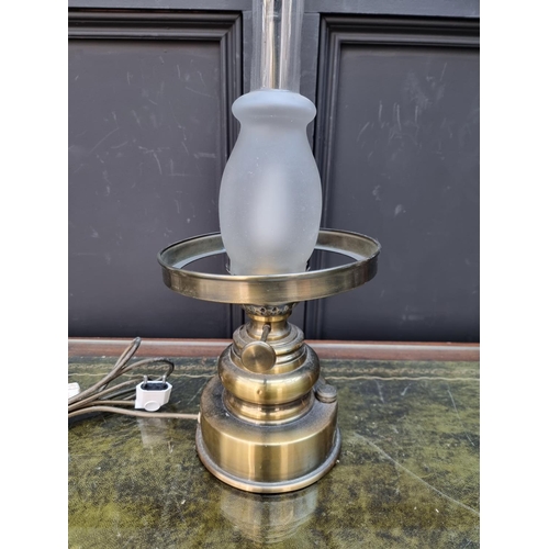 1284 - A reproduction lacquered brass table lamp, labelled 'Drawing Petrol Lamps'. ... 