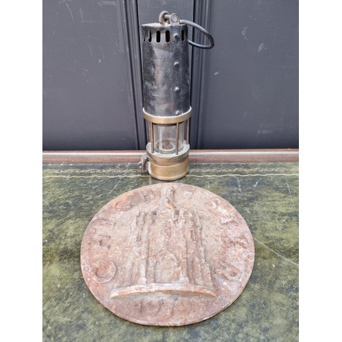 1287 - An old brass miner's lamp; together with a cast iron 'Chichester' plaque, 22.5cm diameter.... 