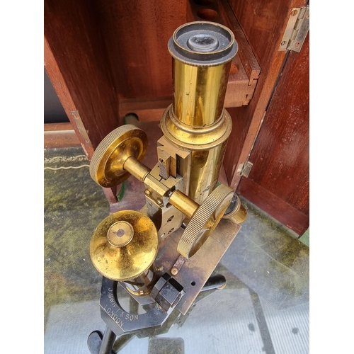 1297 - An old brass microscope, by J Swift & Sons, No.11993, in mahogany box. 