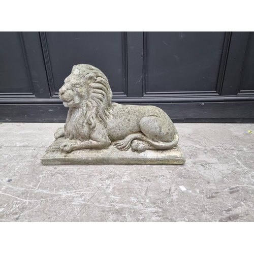 1357 - An old weathered composition stone recumbent lion, 61cm long.