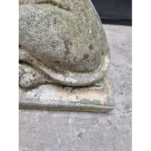 1357 - An old weathered composition stone recumbent lion, 61cm long.