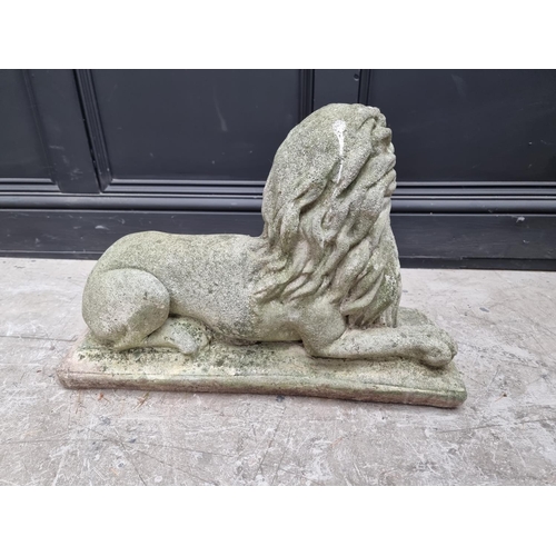 1357 - An old weathered composition stone recumbent lion, 61cm long.