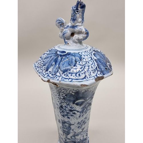 1359 - A tin glazed pottery delftware vase and cover, 18th/19th century, painted with a Chinese figure, 35.... 