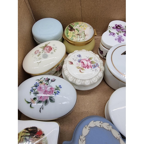 1378 - A collection of small porcelain boxes and covers.