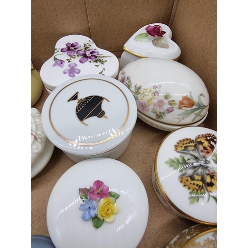 1378 - A collection of small porcelain boxes and covers.