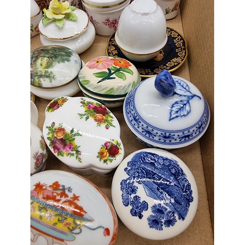 1378 - A collection of small porcelain boxes and covers.