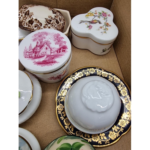 1378 - A collection of small porcelain boxes and covers.