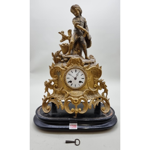 1386 - A late 19th century gilt spelter mantel clock, 43.5cm high, with pendulum, on ebonized stand.&n... 