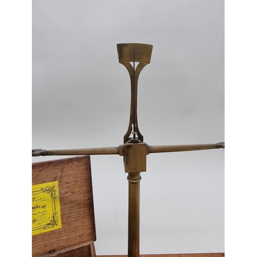 1387 - A 19th century oak cased set of balance scales, labelled W & T Avery, with weights; togethe... 