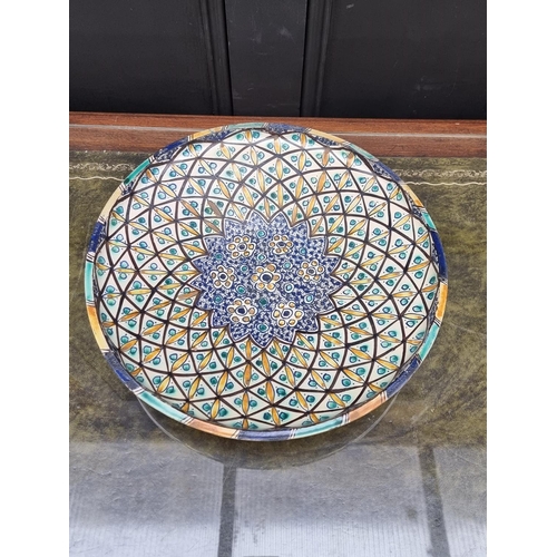 1406 - An Iznik pottery charger, 38cm diameter. 