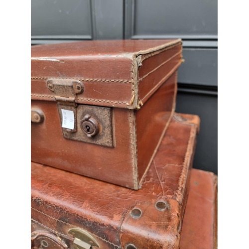 1416 - Three vintage leather suitcases, largest 66.5cm wide. 