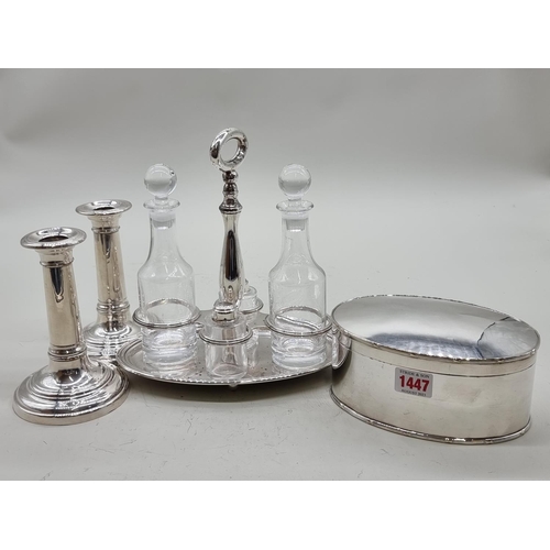 1447 - A small group of silver plate, comprising a cruet stand, 22cm wide; an Old Sheffield plate oval... 