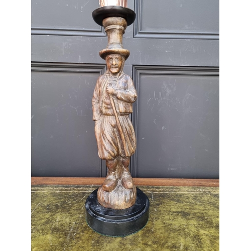 1461 - A carved wood figural candlestick, total height 56.5cm. 