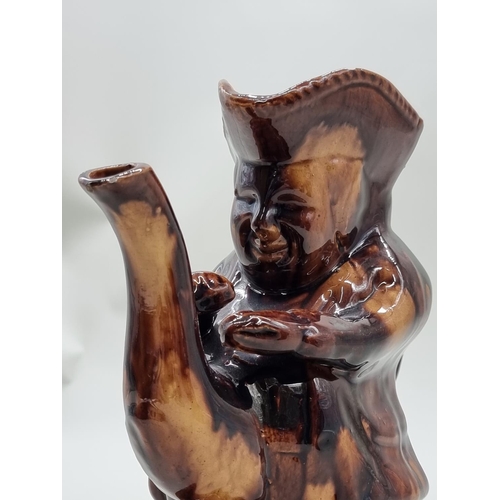 1483 - Three Victorian treacle glazed toby jugs, two with covers, largest 26cm high, (s.d).... 