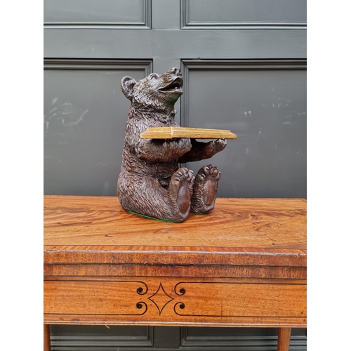 1498 - A resin Black Forest style seated bear, 35.5cm high. 