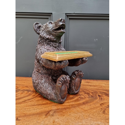 1498 - A resin Black Forest style seated bear, 35.5cm high. 