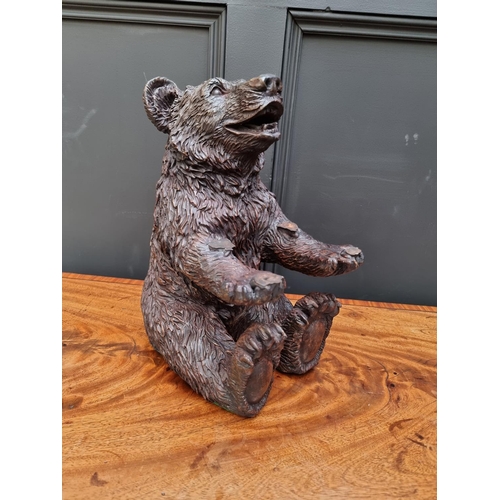 1498 - A resin Black Forest style seated bear, 35.5cm high. 