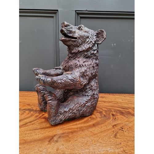 1498 - A resin Black Forest style seated bear, 35.5cm high. 