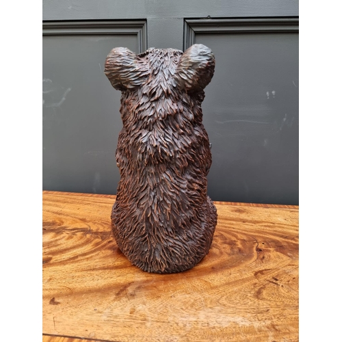 1498 - A resin Black Forest style seated bear, 35.5cm high. 