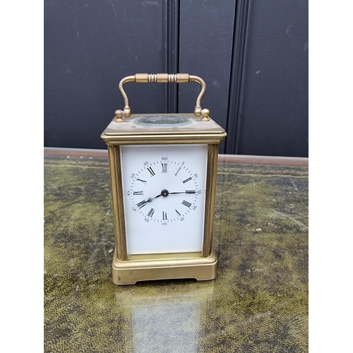 1517 - An old brass carriage timepiece, height including handle 14.5cm. 