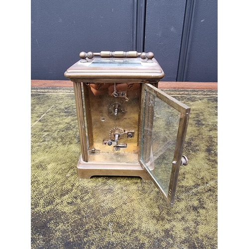 1518 - An old brass carriage timepiece, height including handle 14.5cm, with associated black leather ... 