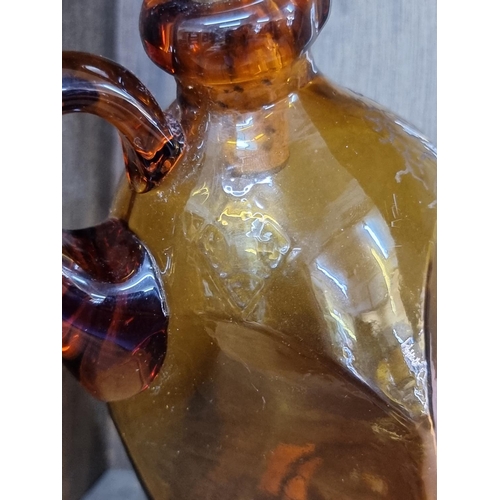 1543 - A Victorian amber glass whisky jug and mother of pearl stopper, with etched registration lozenge, he... 