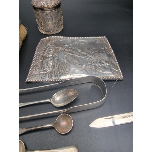 102 - A group of silver, to include cutlery; dressing table accessories; and a silver book cover, 175g wei... 