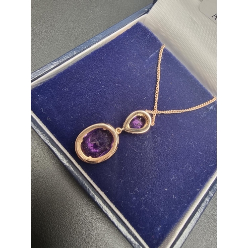 139 - An 18ct gold amethyst and diamond pendant on a 9ct gold chain, each amethyst surrounded by a border ... 