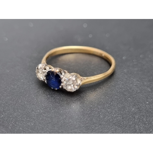 155 - A yellow metal sapphire and diamond three stone ring, set facetted sapphire and two old cut diamonds... 