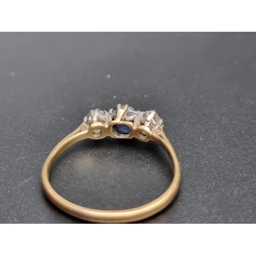 155 - A yellow metal sapphire and diamond three stone ring, set facetted sapphire and two old cut diamonds... 