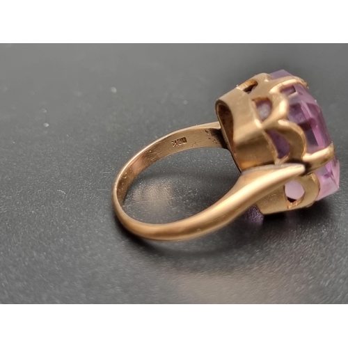 156 - A yellow metal amethyst ring, stamped, size L 1/2.