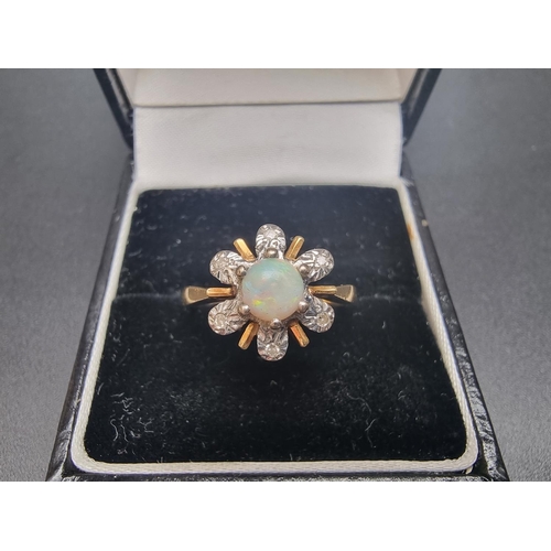 157 - A yellow metal ring, set central cabochon opal surrounded by six diamonds, stamped '18ct', size M 1/... 