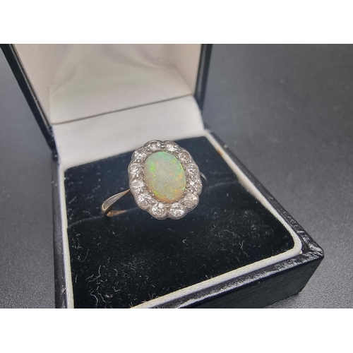 160 - A yellow metal opal and diamond cluster ring, set oval cabochon opal surrounded by twelve diamonds, ... 