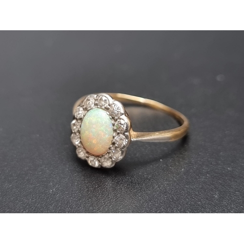 160 - A yellow metal opal and diamond cluster ring, set oval cabochon opal surrounded by twelve diamonds, ... 