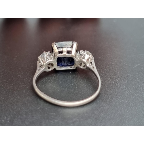 162 - A white metal synthetic sapphire and diamond three stone ring, set central sapphire and two old cut ... 